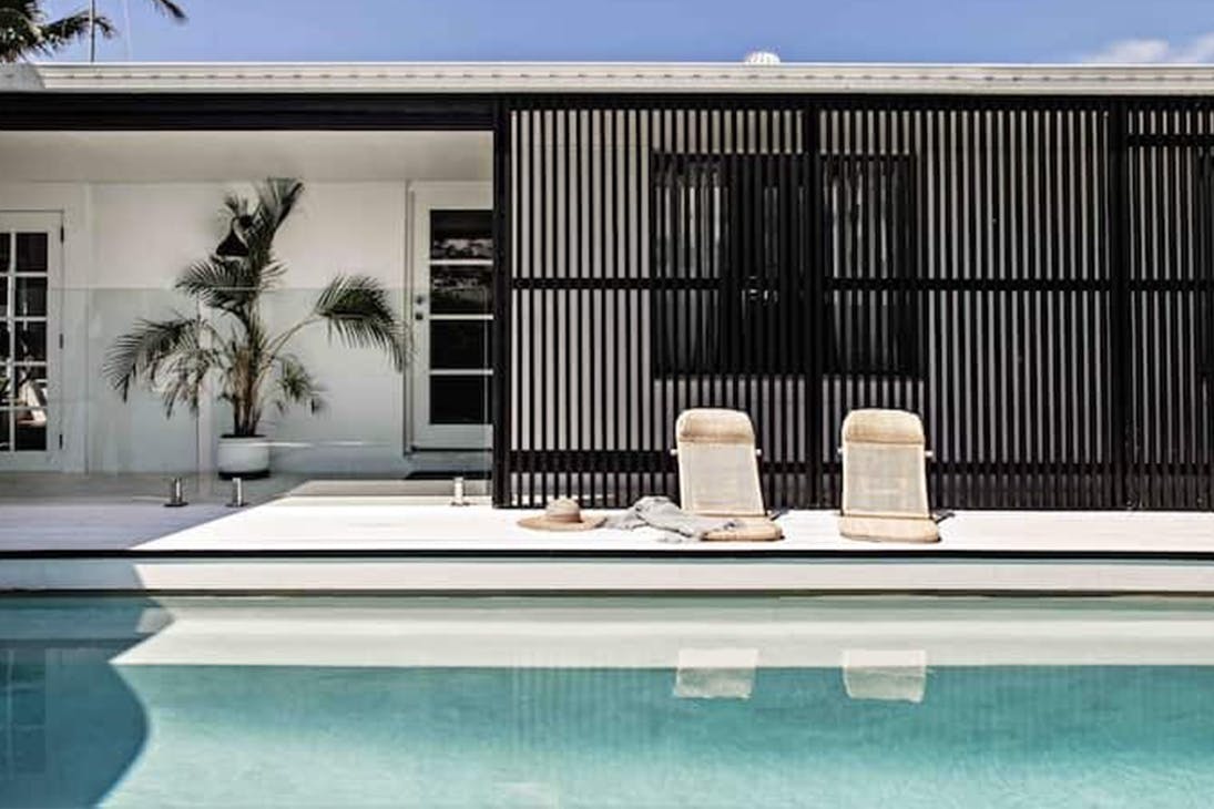A coastal style cottage, with a pool.